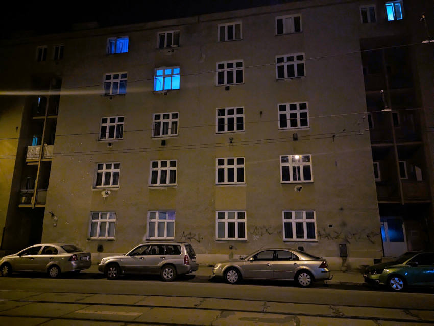 A concrete Brno apartment block at night