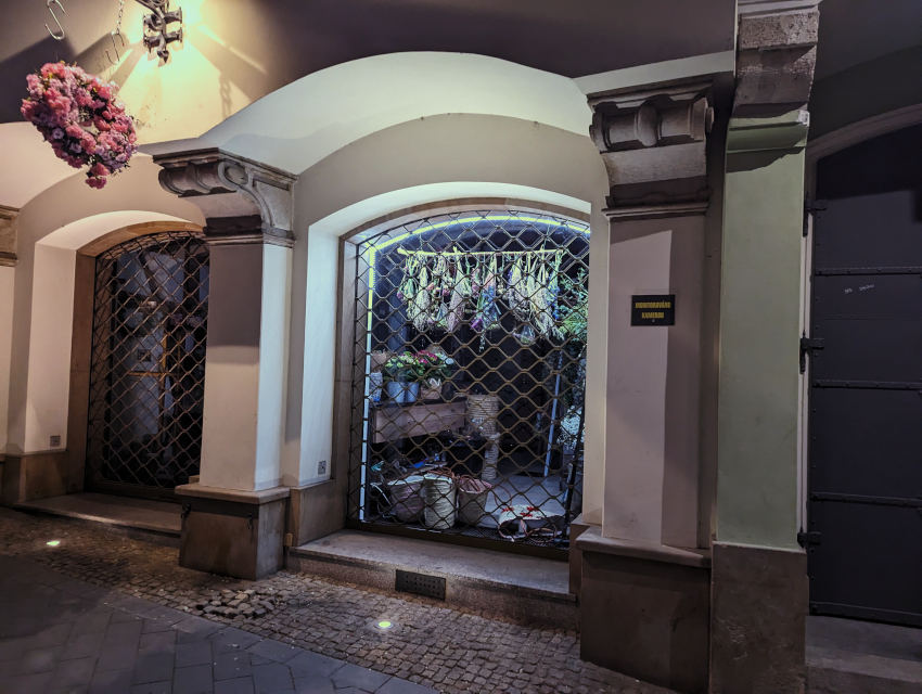 A shuttered Brno florist shop at night