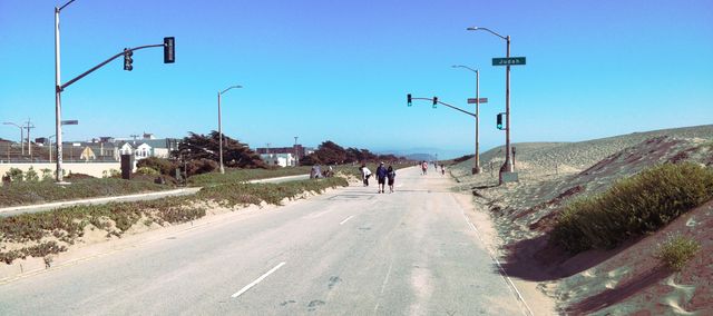 Pedestrians walking the Upper Great Highway in San Francisco